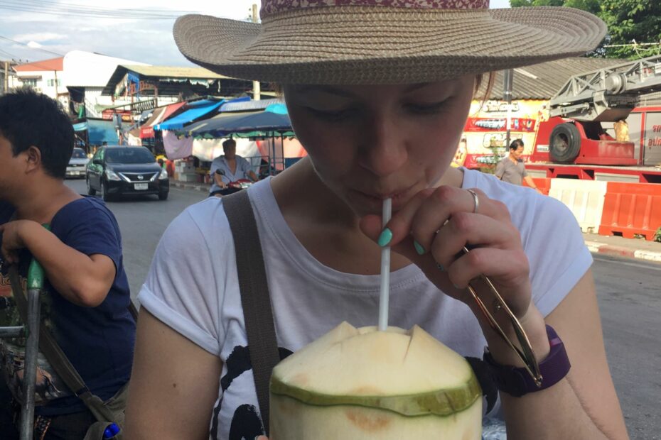 girl drinking from a coconut